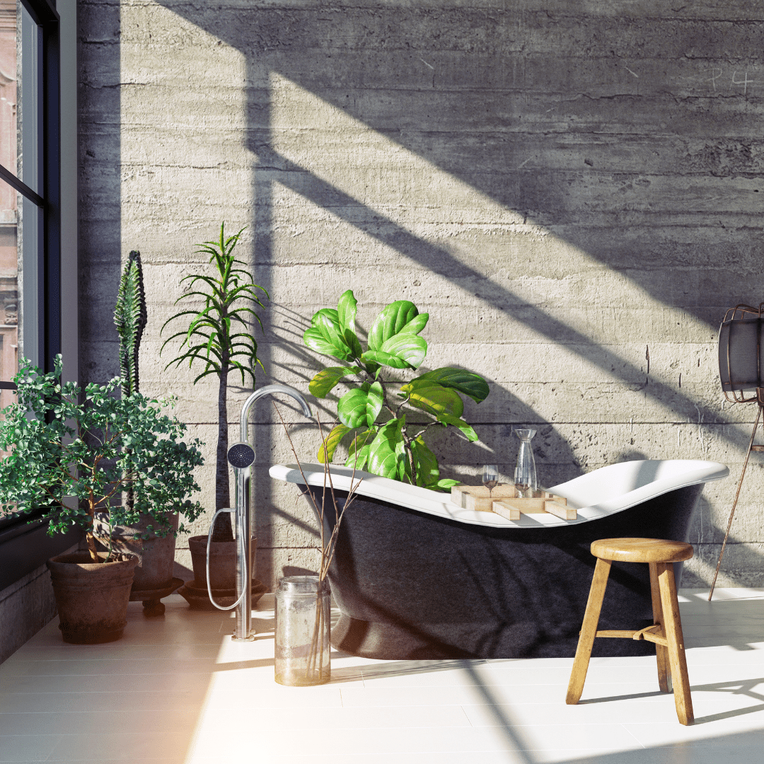 black bathtub surrounded by greenery